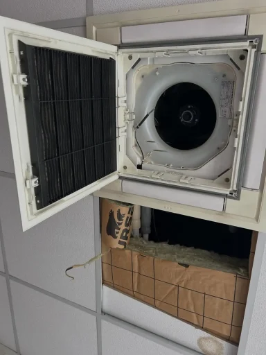 Gros caisson de ventilation ou de climatisation avec la porte ouverte, montrant un grand ventilateur circulaire à l'intérieur.